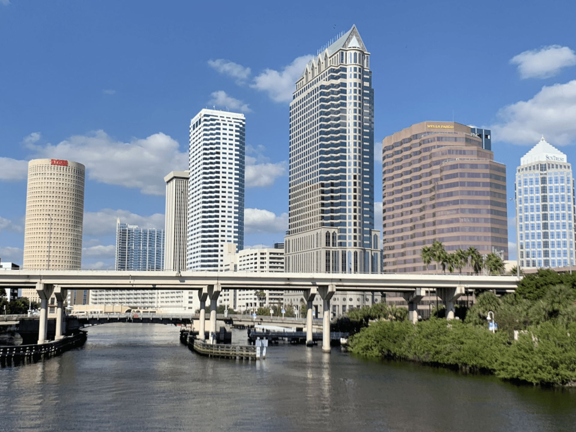 a city with tall buildings and a lake